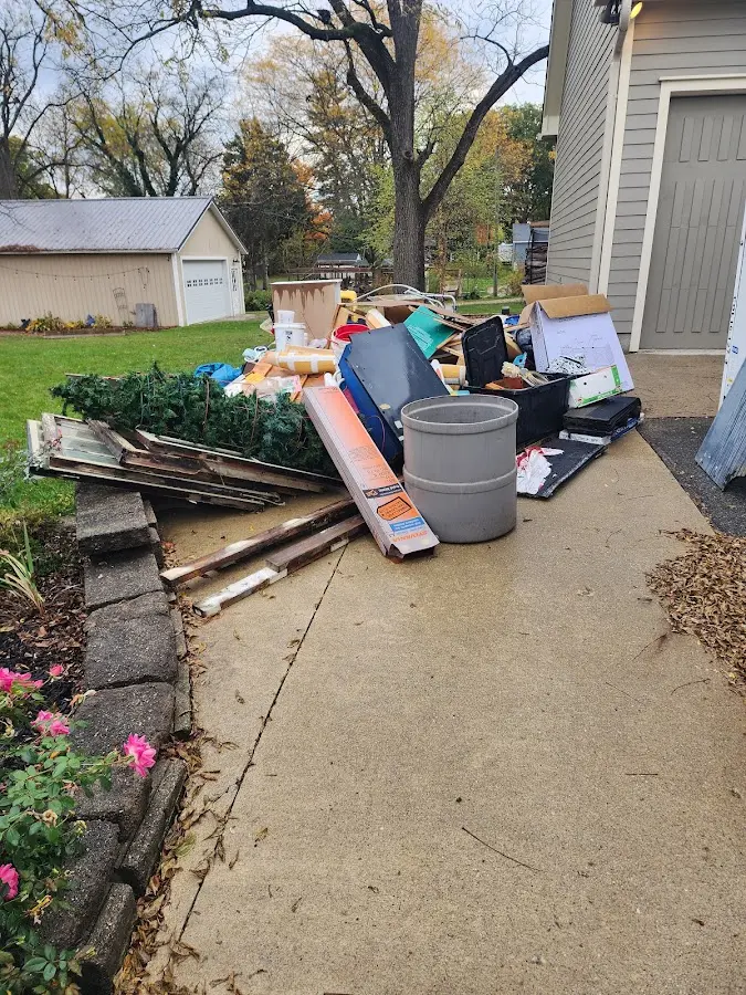Dumpster being loaded with debris for Roofing Dumpster Rental in Spring Creek